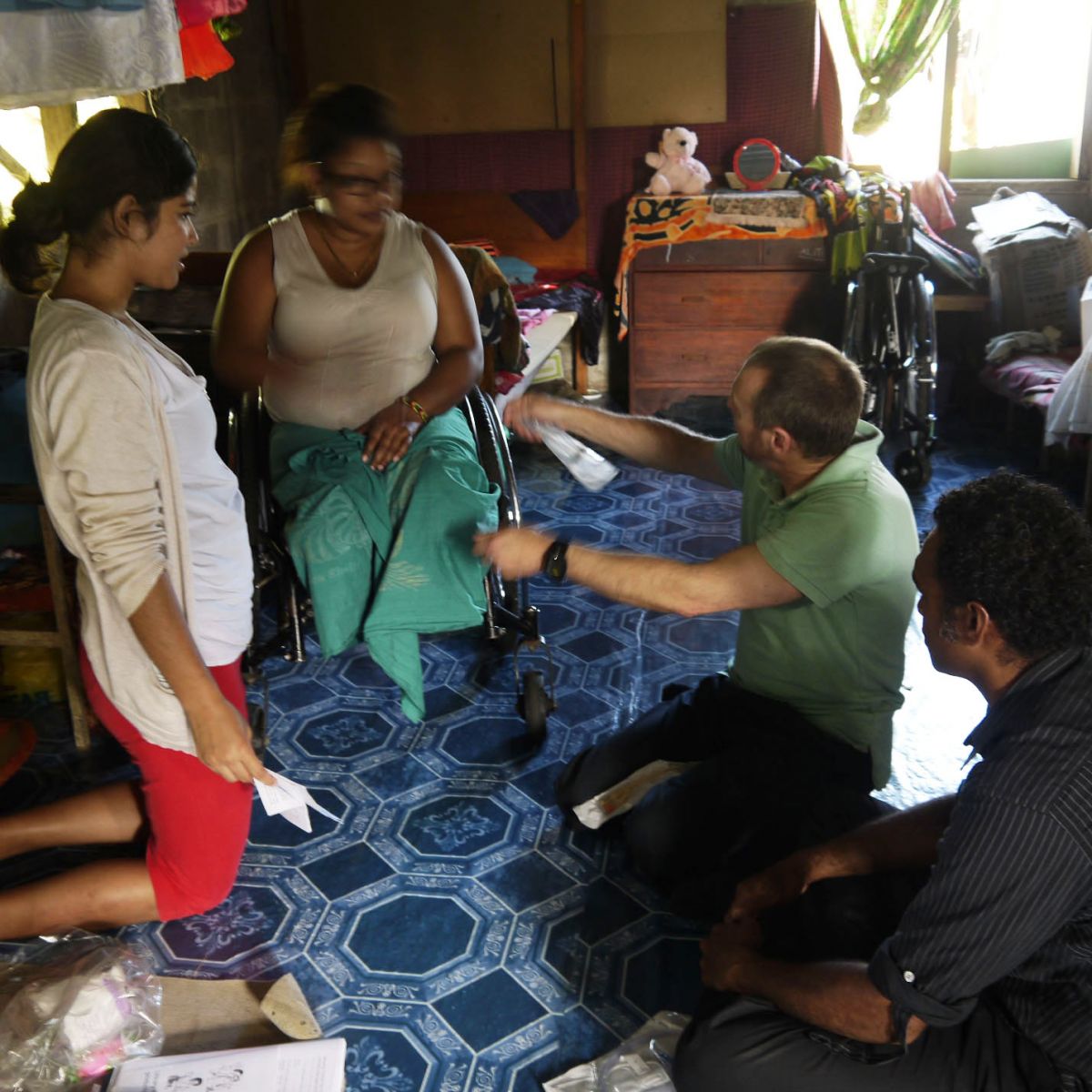 Motivation Australia staff present spinal cord injury patients in Fiji with Paralogic product
